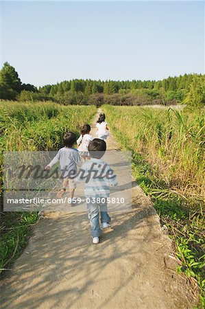 Children Running on Rural Walkway