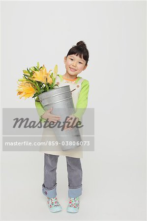 Girl Holding A Bucket With Flowers