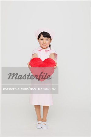 Girl Dressed As Nurse Holding Heart