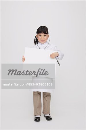 Girl Dressed Up As Doctor Holding Placard