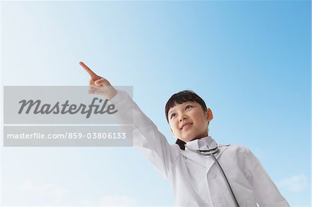 Girl Dressed As Doctor Smiling Against Blue Sky