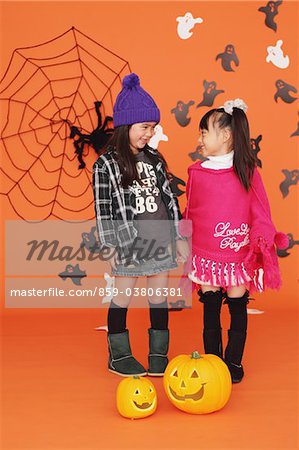 Girls dressed up for Halloween Standing Face To Face