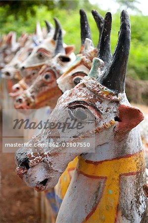 India, Chettinad. Terracotta horses lined up by the Ayyanar Temple. Although they have horns and look distinctly bovine, we are assured they are indeed horses!