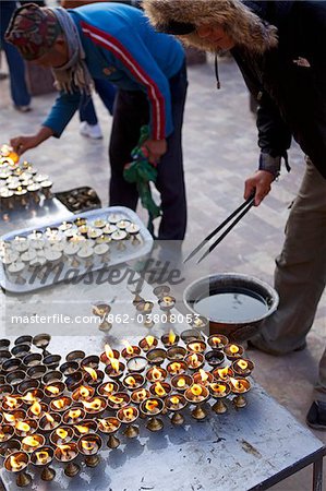 Nepal, Kathmandu, Swayambhunath Temple also known as the 'Monkey Temple' is one of the oldest religious sites in Nepal. Pilgrims making offerings after climbing in the cool of the early morning to the temples summit