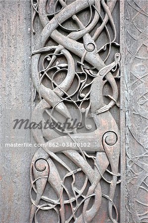 Norway, Urnes, Stave Church. A door panel on the outside wall, depicting mythical creatures entwined among foliage. This carving is depicted on the reverse of the 50 ore coin.
