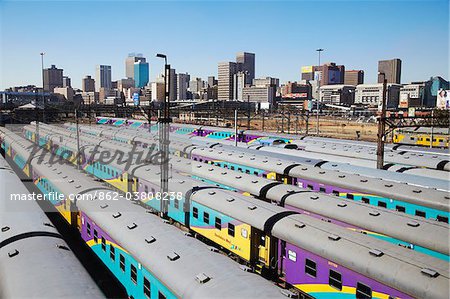 Train carriages at Park Station with city skyline in background, Johannesburg, Gauteng, South Africa