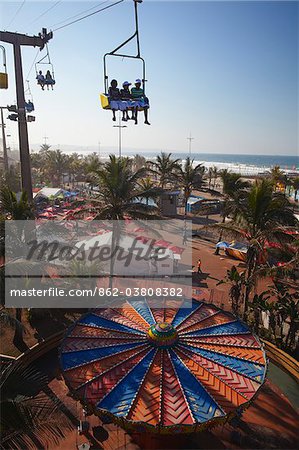 Chair lift above funfair along beachfront, Durban, KwaZulu-Natal, South Africa