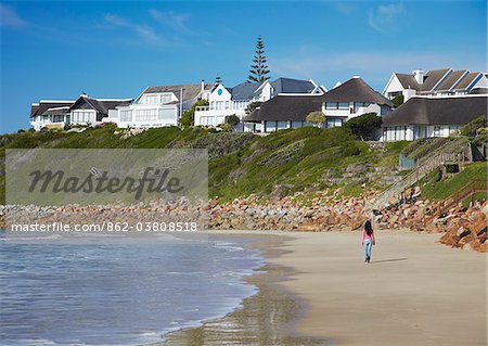 Woman walking on beach at St Francis Bay, Western Cape, South Africa Woman walking on beach at St Francis Bay, Western Cape, South Africa