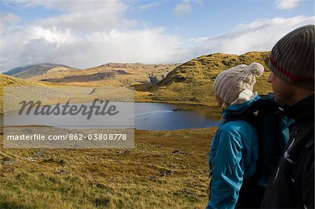 UK, North Wales, Snowdonia.  Man and woman trekking on the flanks of Mt Snowdon.