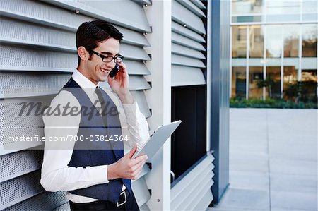 Businessman with Cell Phone and Tablet PC