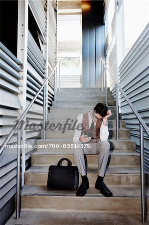 Frustrated Businessman Sitting on Stairs