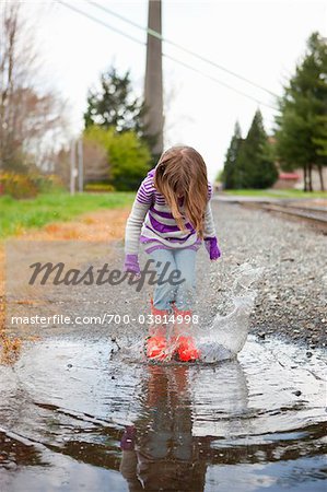 Girl Jumping in Puddle