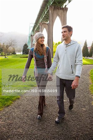 Couple Walking under St John's Bridge, Portland, Oregon, USA Couple Walking under St John's Bridge, Portland, Oregon, USA