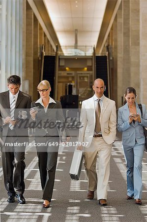 Business people walking down a corridor Business people walking down a corridor