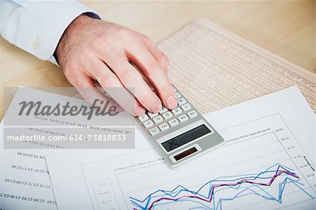 Office worker using calculator