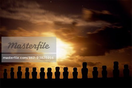 Moonrise over the fifteen colossal stone statues or moais of Tongariki. The moais stand on their platform or ahu on the eastern coast of the island at the foot of the Poike Peninsula. Ahu Tongariki is the largest platform on the island at over 200m in length and has the most maois.