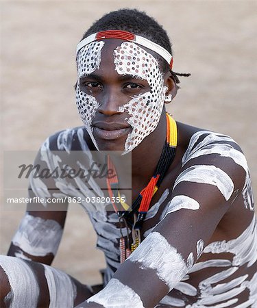 Karo men excel in body art. They decorate their faces and torsos elaborately using local white chalk, pulverised rock and other natural pigments. Their braided hairstyles are typical of young men from the tribe.The Karo are a small tribe living in three main villages along the lower reaches of the Omo River in southwest Ethiopia.