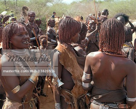 A group of Hamar women at a Jumping of the Bull ceremony.The Hamar are semi nomadic pastoralists of Southwest Ethiopia whose women wear striking traditional dress and style their red ochred hair mop fashion.The Jumping of the Bull ceremony is a rite of passage for young men.