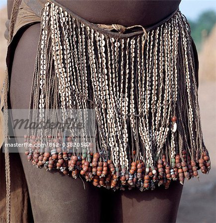 The decorated leather apron or skirt of a young Nyangatom girl. The numerous white discs woven into the strands of braided leather are made of ostrich shell.The Nyangatom are one of the largest tribes and arguably the most warlike people living along the Omo River in Southwest Ethiopia.