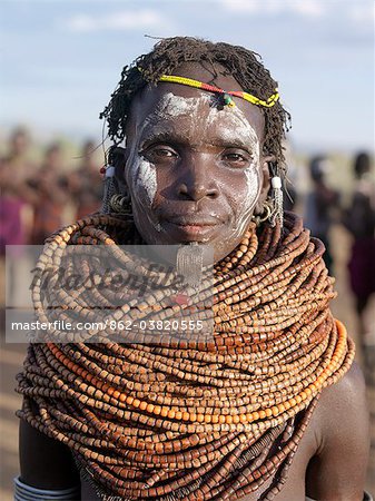A Nyangatom woman wears numerous strands of beads made from wood.The Nyangatom are one of the largest tribes and arguably the most warlike people living along the Omo River in Southwest Ethiopia. They form a part of the Ateger speaking people  a cluster of seven eastern Nilotic tribes to which the Turkana of Northern Kenya and the Karamajong of Eastern Uganda belong.