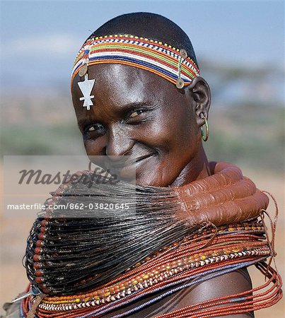 A Samburu woman wearing a mporro necklace, which denotes her married status. These necklaces were once made of hair from giraffe tails but nowadays, the fibres of doum palm fronds, Hyphaene coriacea, are used instead.The red beads after which the necklace is named are wound glass beads made in Venice c.1850.