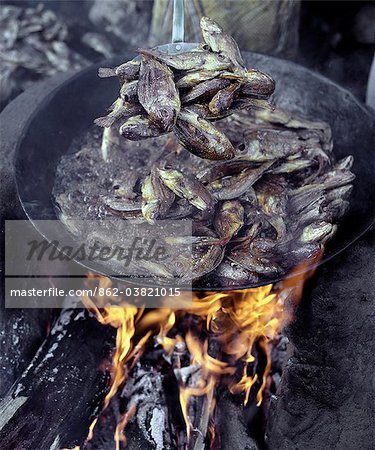 Small tilapia fish caught in Lake Rukwa, Southwest Tanzania, are deep fried before being sent to market in Mbeya, the commercial centre of the fertile Southern Highlands region.Lake Rukwa is a long, narrow lake lying in a basin of inland drainage southeast of Lake Tanganyika.
