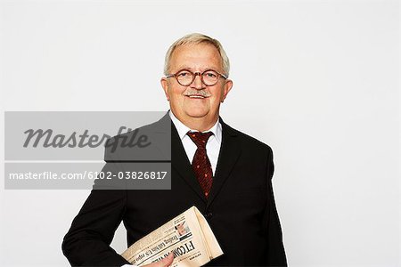 A man in a suit holding a paper.