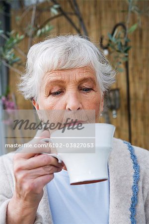 Woman drinking a cup of coffee.