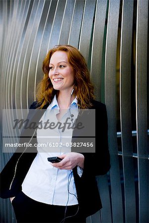 Woman with a headset and a cellphone, Stockholm, Sweden.