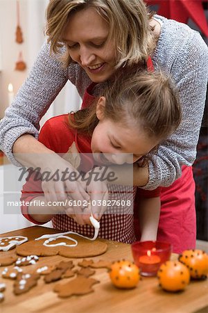 Mother and daughter baking gingerbread biscuits, Sweden.
