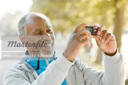Senior man taking pictures, Sweden.