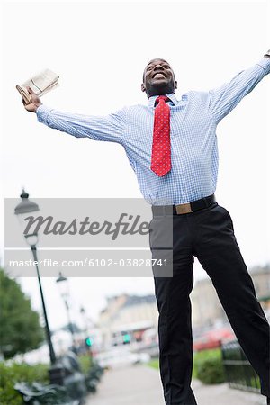 A businessman jumping in a park, Stockholm, Sweden.