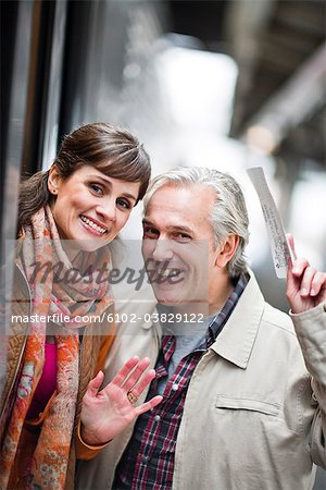 A couple by a train at a railway station, Sweden.