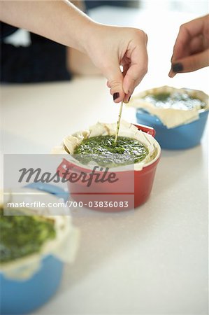 Woman Poking Toothpick into Kale Quiche