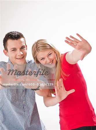 Teenagers Holding up Hands