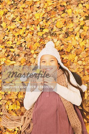 Preteen Girl Lying In Leaves