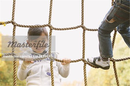 Girl Climbing On Ropes