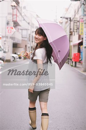 Young adult woman with umbrella