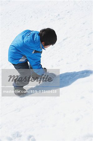 Boy Climbing Up In Snow