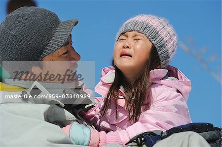 Father Pampering His Daughter Who Is Crying