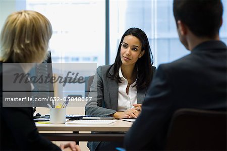 Female executive talking to business partners