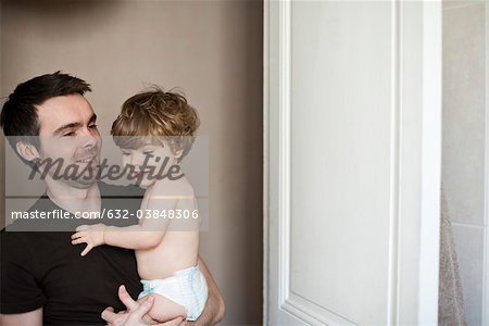 Father holding toddler son