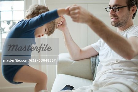 Toddler boy playing with father