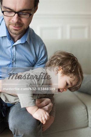 Father and toddler son playing