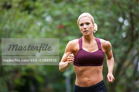 Woman Jogging through Park, Seattle, Washington, USA