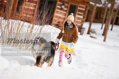 Girl with Dog Outdoors in Winter