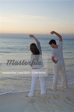 Couple Exercising on Beach, Reef Playacar Resort and Spa, Playa del Carmen, Mexico