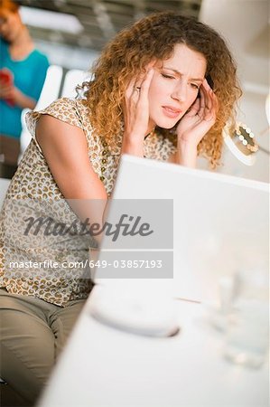 Frustrated businesswoman using laptop