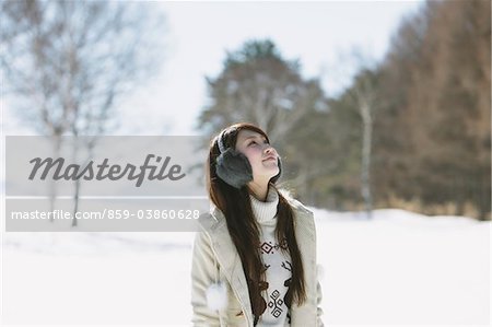 Teenage Girl Wearing Winter Clothing Looking Up