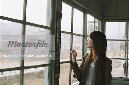 Young Woman In Waiting-Room At Station